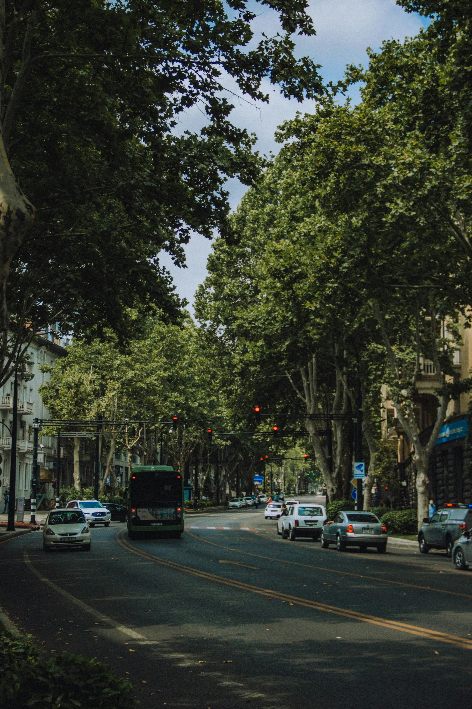 street intersection with several cars and parked vehicles