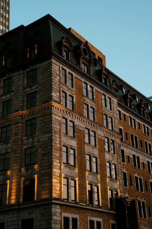 a high rise building with light shinding around windows