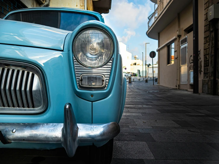 a car parked on the side of a road with a grill grille on it