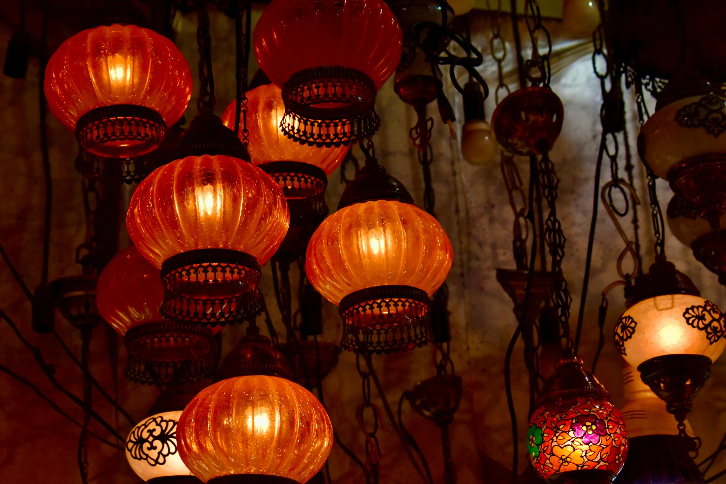 the many hanging lights have red and white lamps