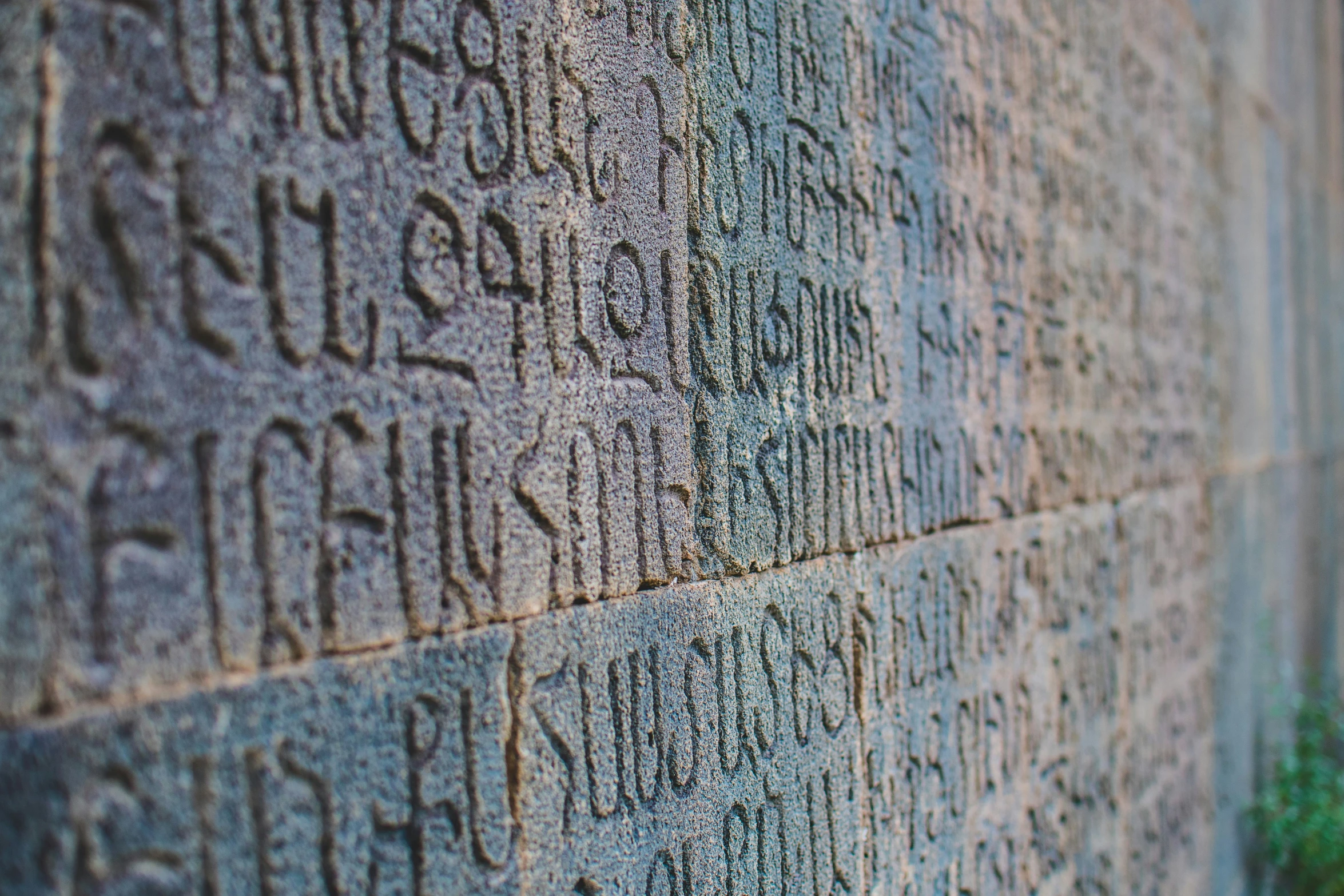 the words are etched into the wall of an old cemetery