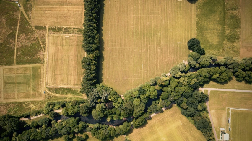 the aerial view of a field and road