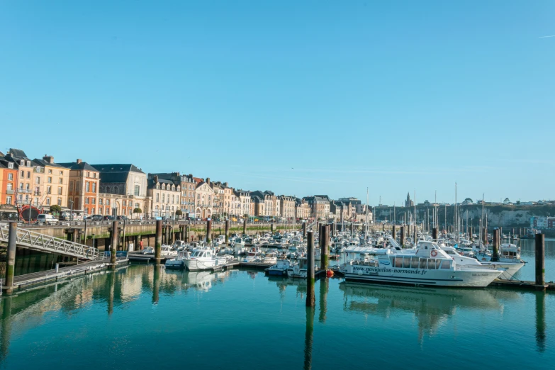 a city by the water with sailboats docked in it