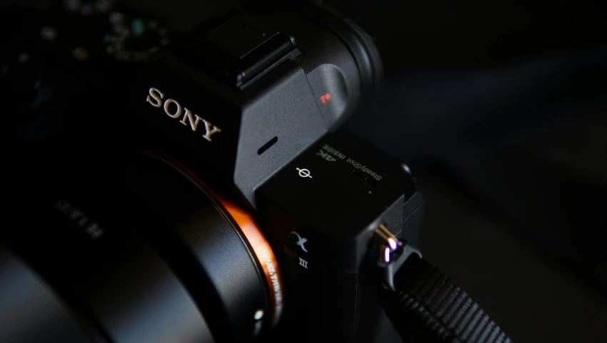 a sony camera is sitting upright with its lens facing forward