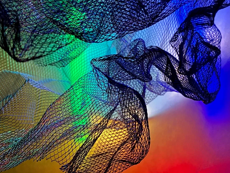 a painting made up of mesh and rainbow colors