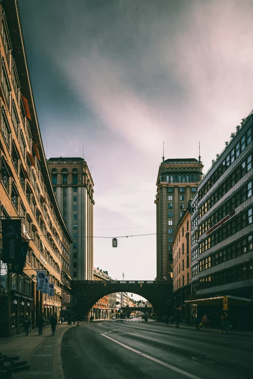 a street lined with tall buildings next to traffic lights