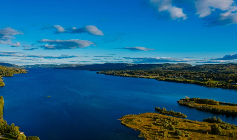 a beautiful lake with trees in the foreground