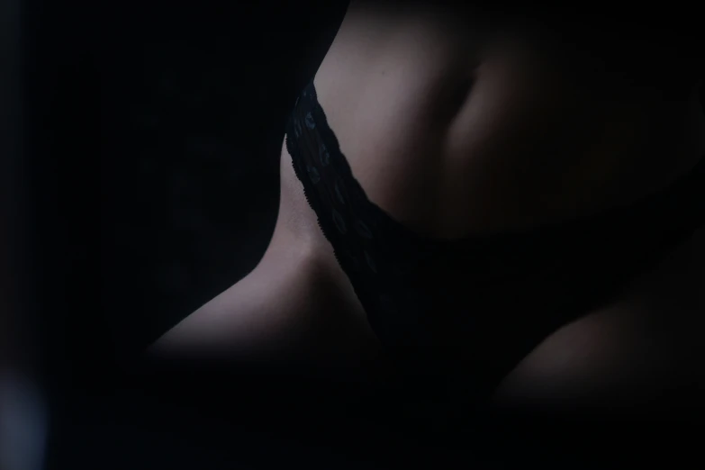 a woman in dark lingerie with black straps