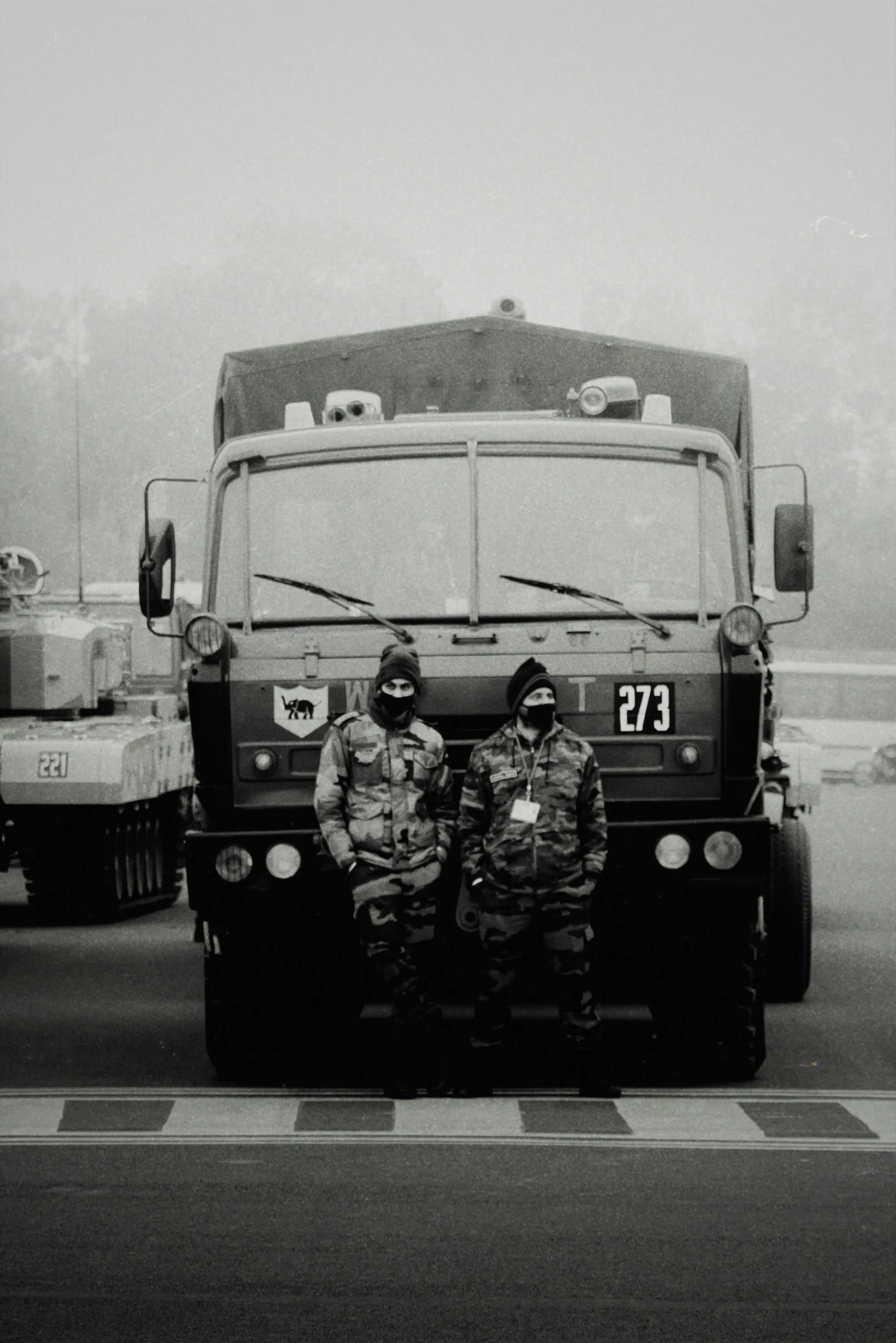 two men are sitting in front of a big truck