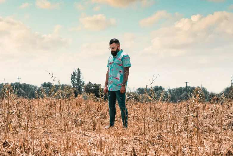 a man is standing in the middle of a field