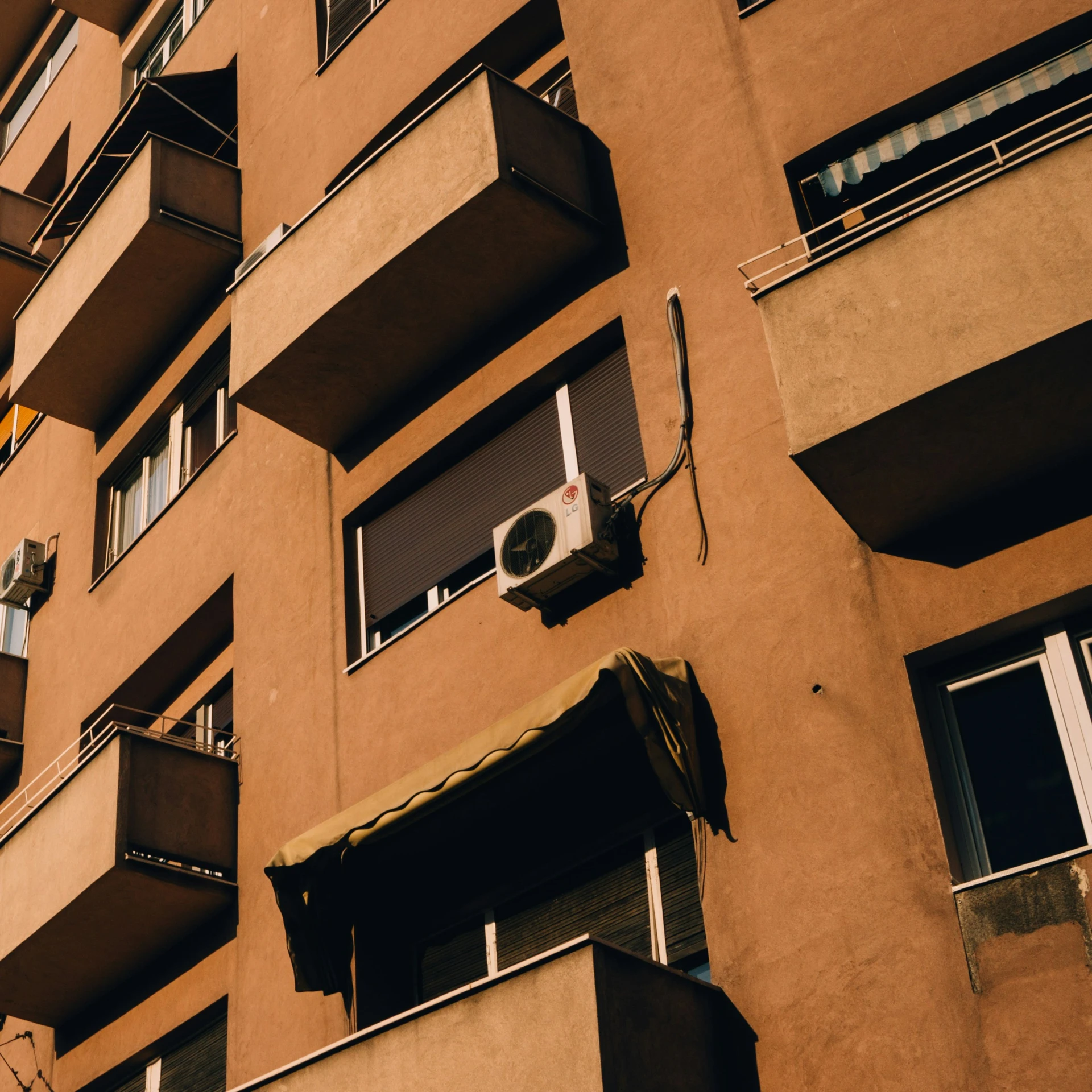 the exterior of an apartment building with lots of balconies