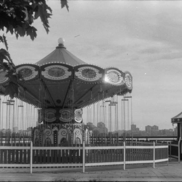 a black and white po shows a carousel and a sidewalk