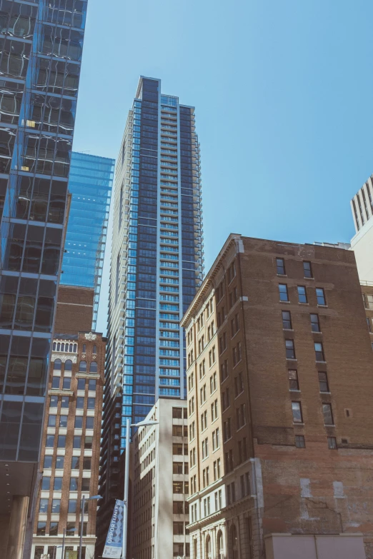 high rise buildings near one another under a blue sky