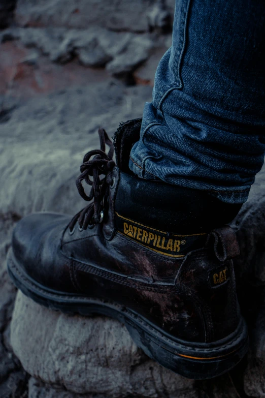 the boots have been worn by someone standing on top of the rocks