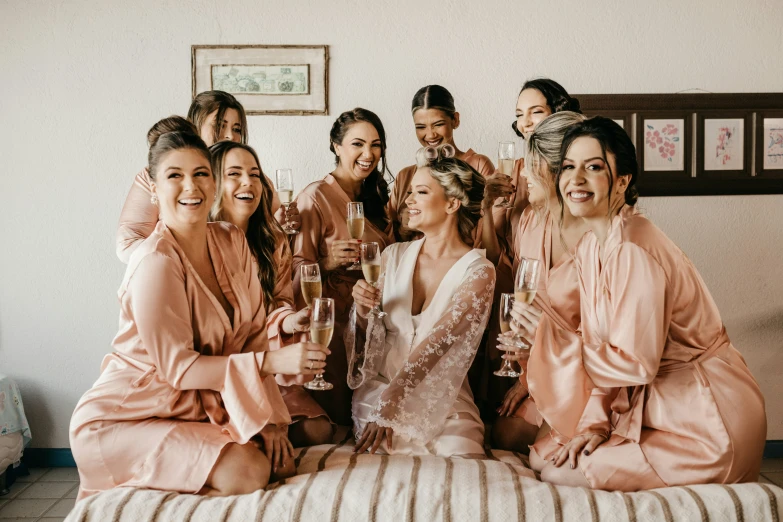 a bunch of women sit and stand together