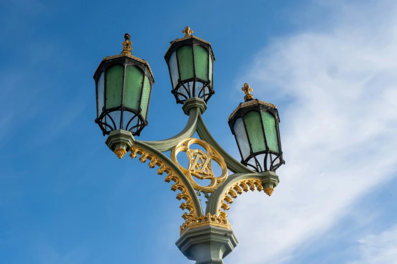 a lamp pole with three light fixtures attached to it