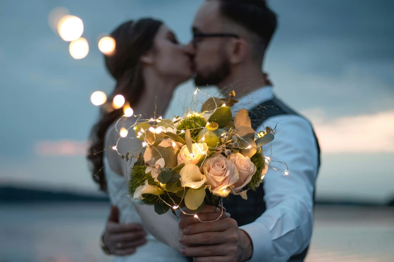 a woman and a man kissing on the beach