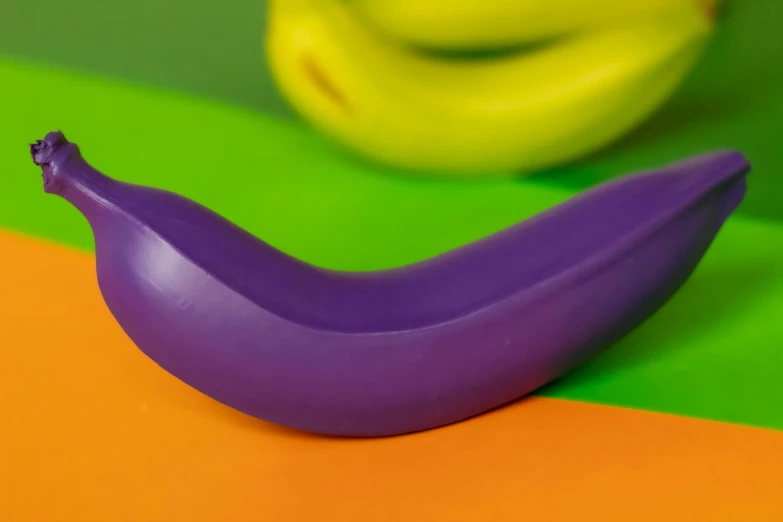 the banana is a purple plastic piece with tiny faces