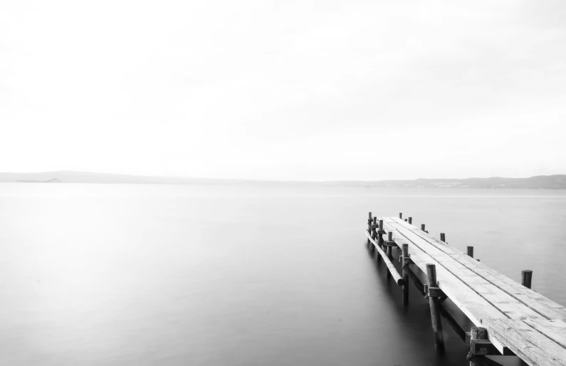 a long wooden dock with people on it