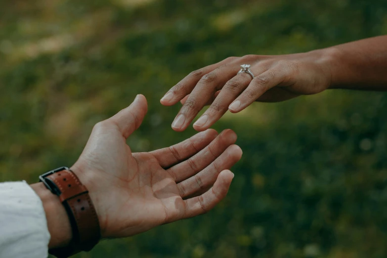 two people reaching out their hands towards each other