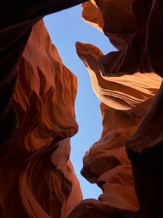 a person is standing in the middle of a rock slot