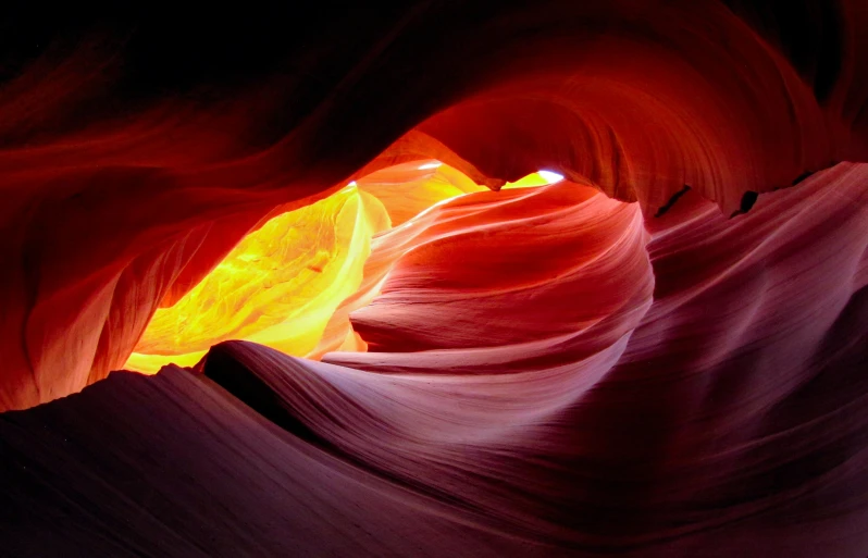 some large red and yellow rocks water and light