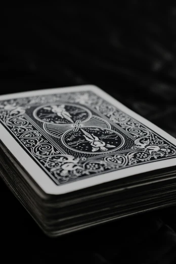the back side of a stack of black and white playing cards
