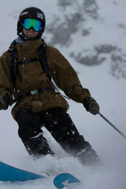 man riding on snowboard down mountain on snowy day