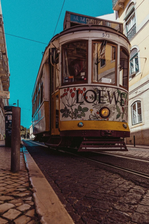 the trolley is on the tracks by some buildings