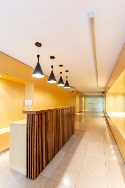 the ceiling light shines on a wall near a long counter