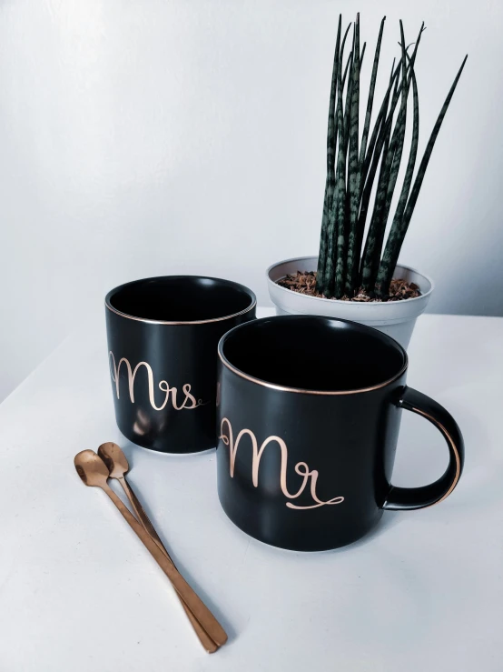 two coffee mugs with name in gold letters