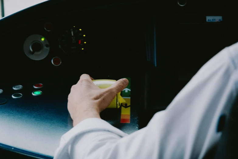 a person in a white shirt is holding soing in a black compartment