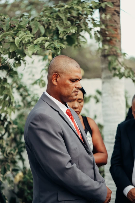 a man in a suit looking at the groom's watch