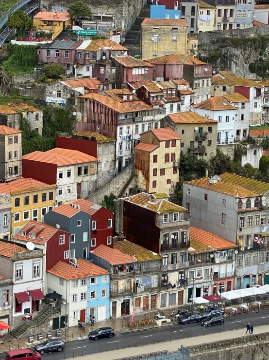 large colorful old buildings on a hillside overlooking a freeway