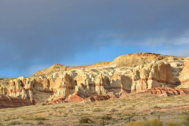 a horse standing in front of rocky landscape