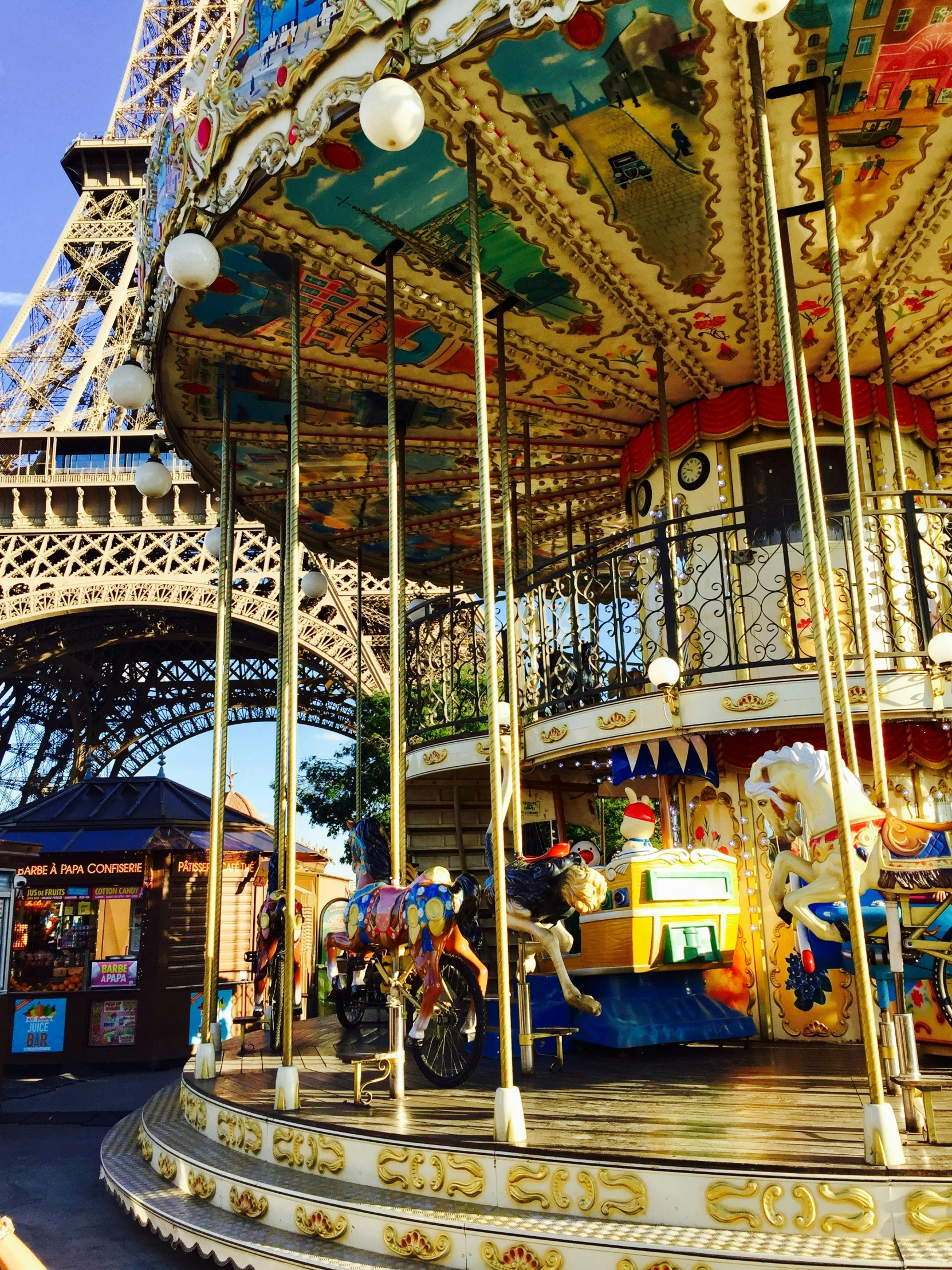 a merry go round with carousels and tables outside