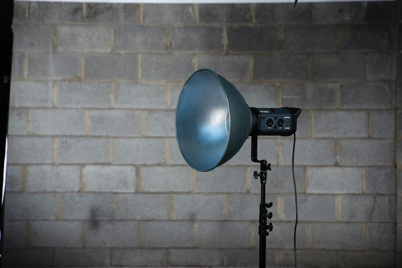 an electric umbrella is on display outside a brick wall