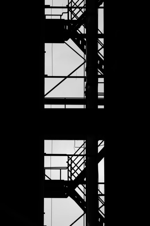 silhouettes of steel rails against a black sky