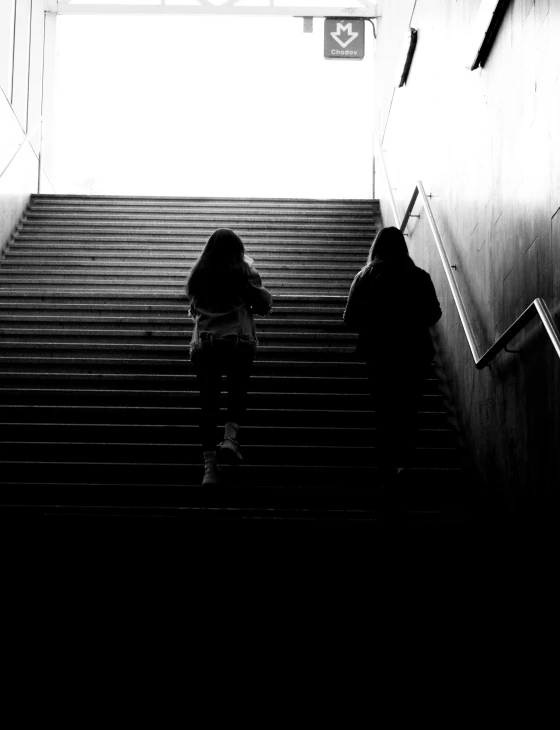 a black and white po shows people on stairs