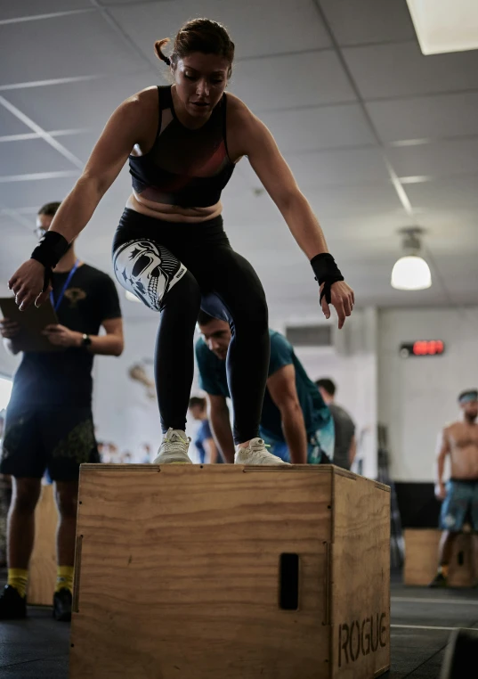 there is a woman standing on top of an item