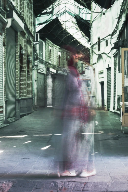 a woman walking down a street with an umbrella