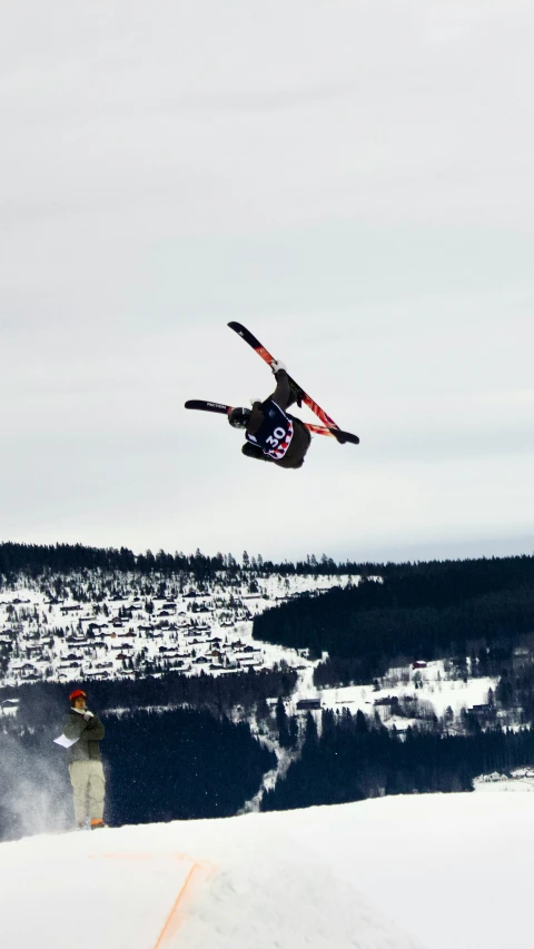 snowboarder performing aerial trick at top of mountain