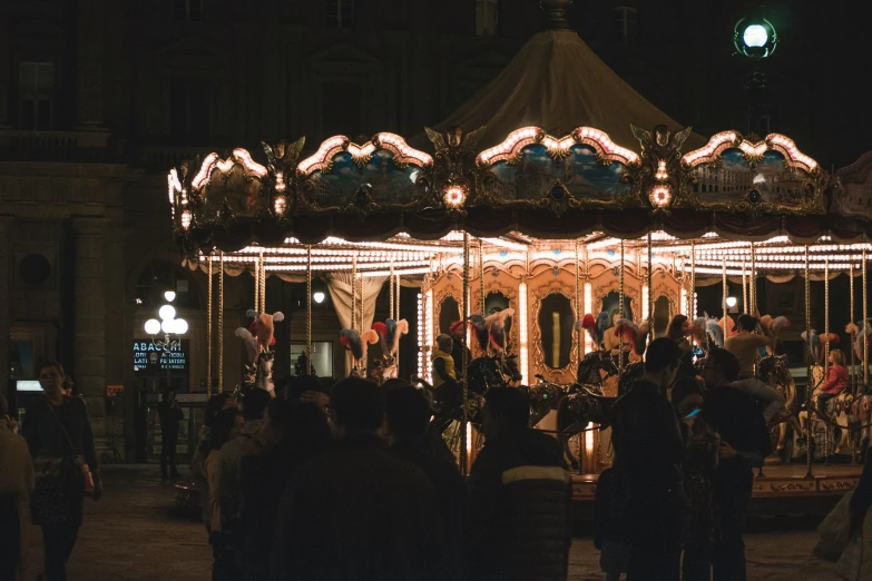 the illuminated merry go round in a city at night