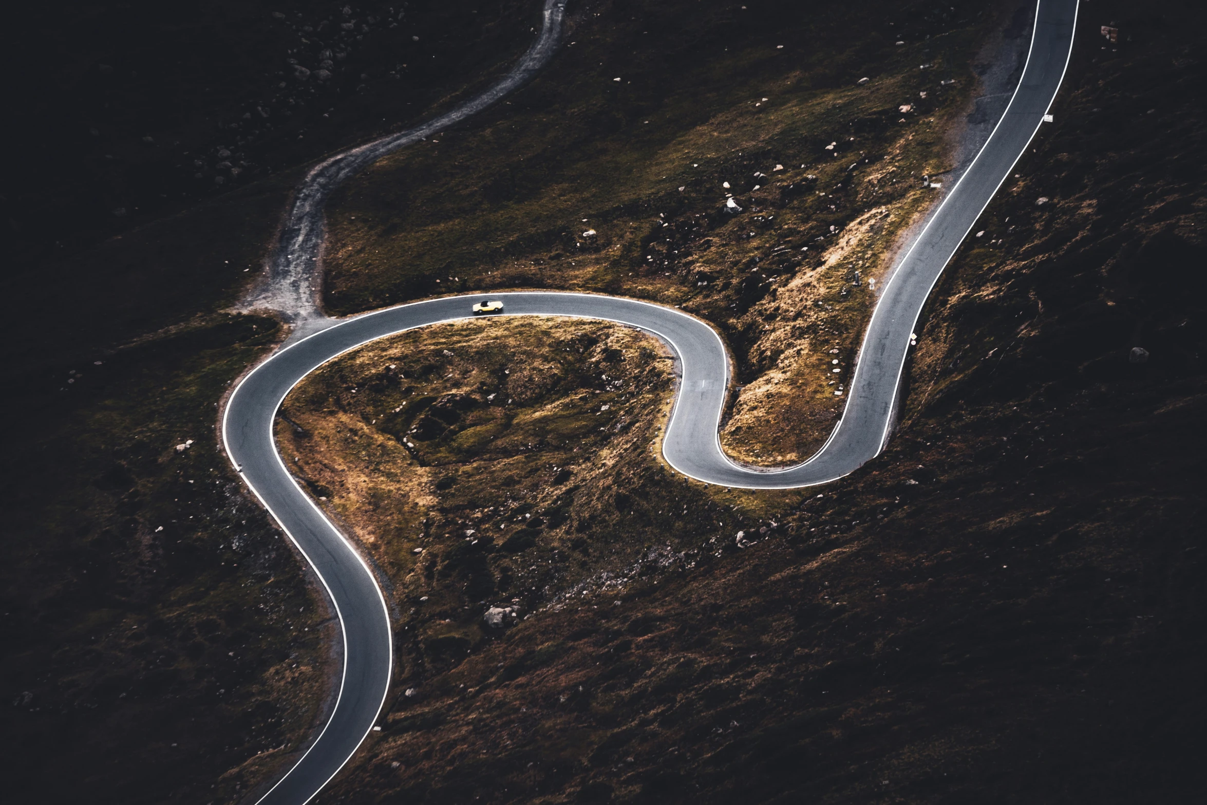 the road is curving right ahead, and has white markings