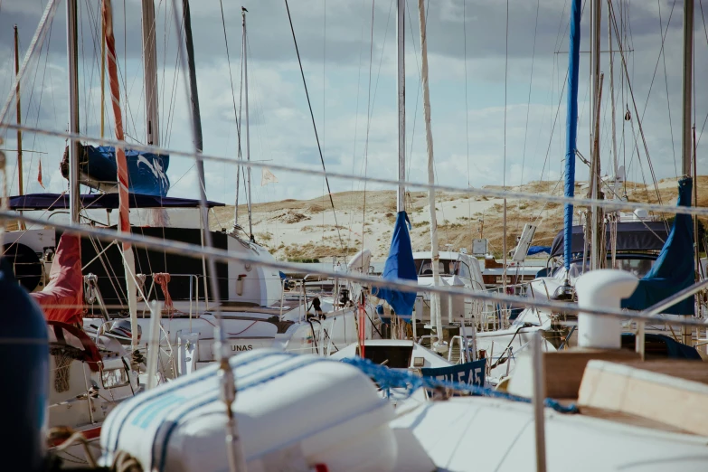 the harbor is filled with small sailboats in it