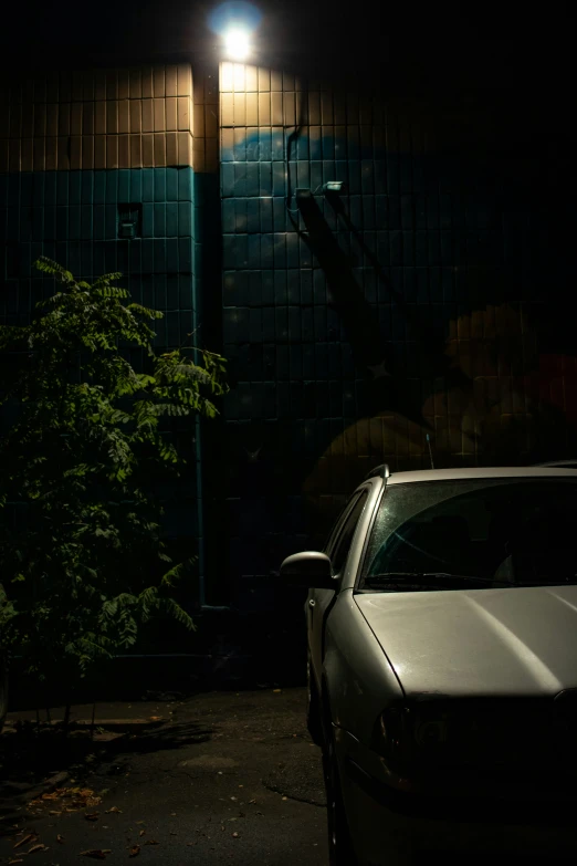 an old car parked in front of a building at night