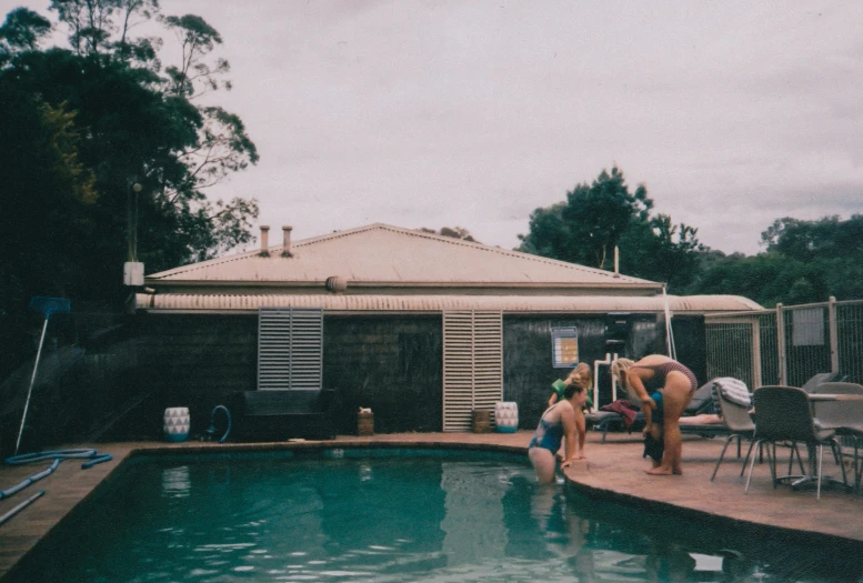 a couple people at the end of an above ground pool