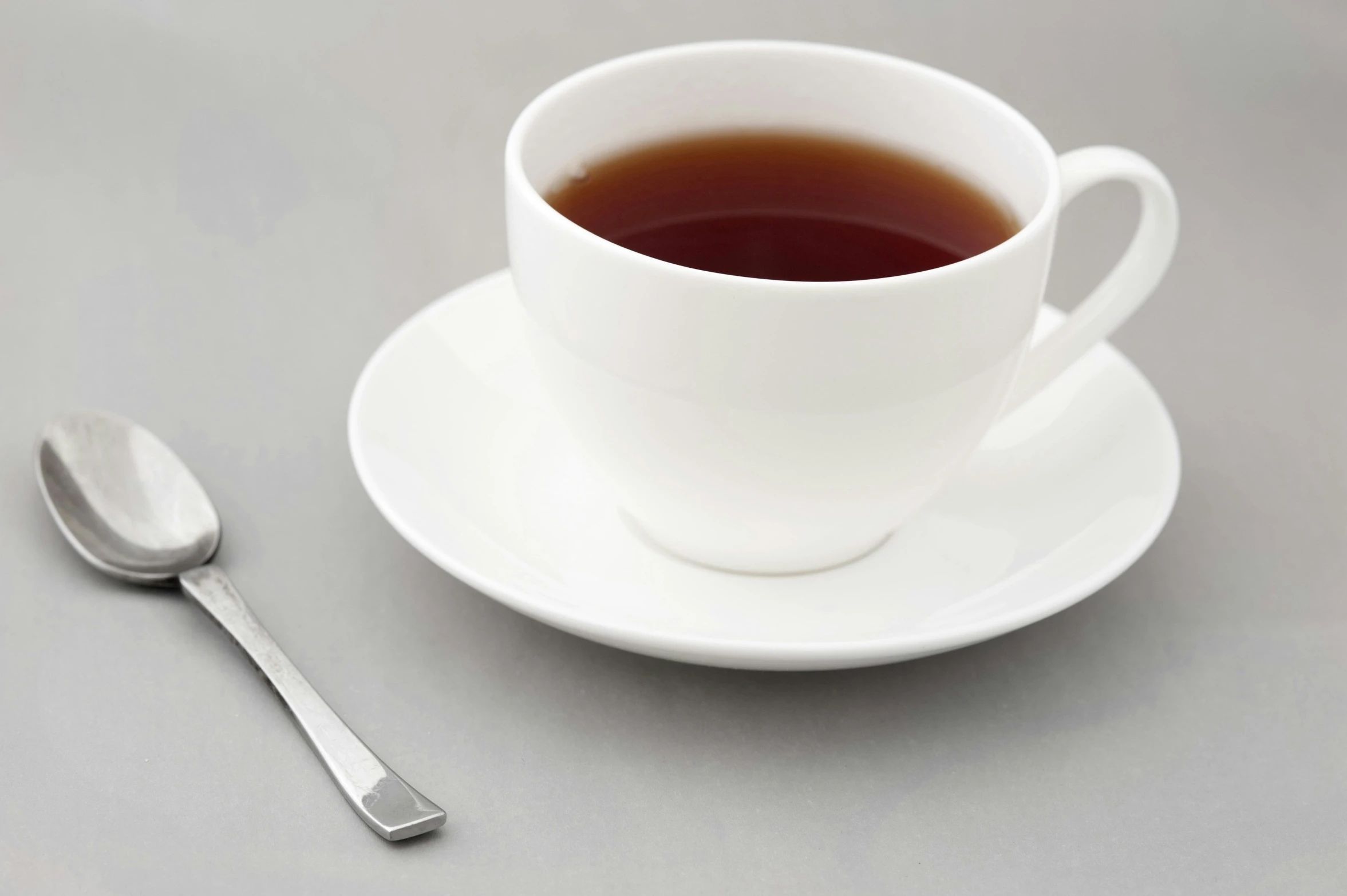 a small cup on a saucer with a spoon