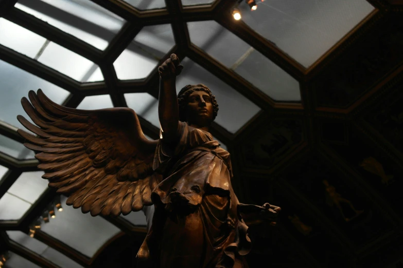 a statue of a woman with large wings in a building