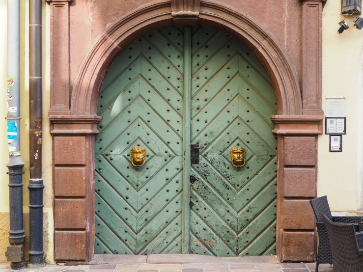 a close up of an ornate wooden door on a building